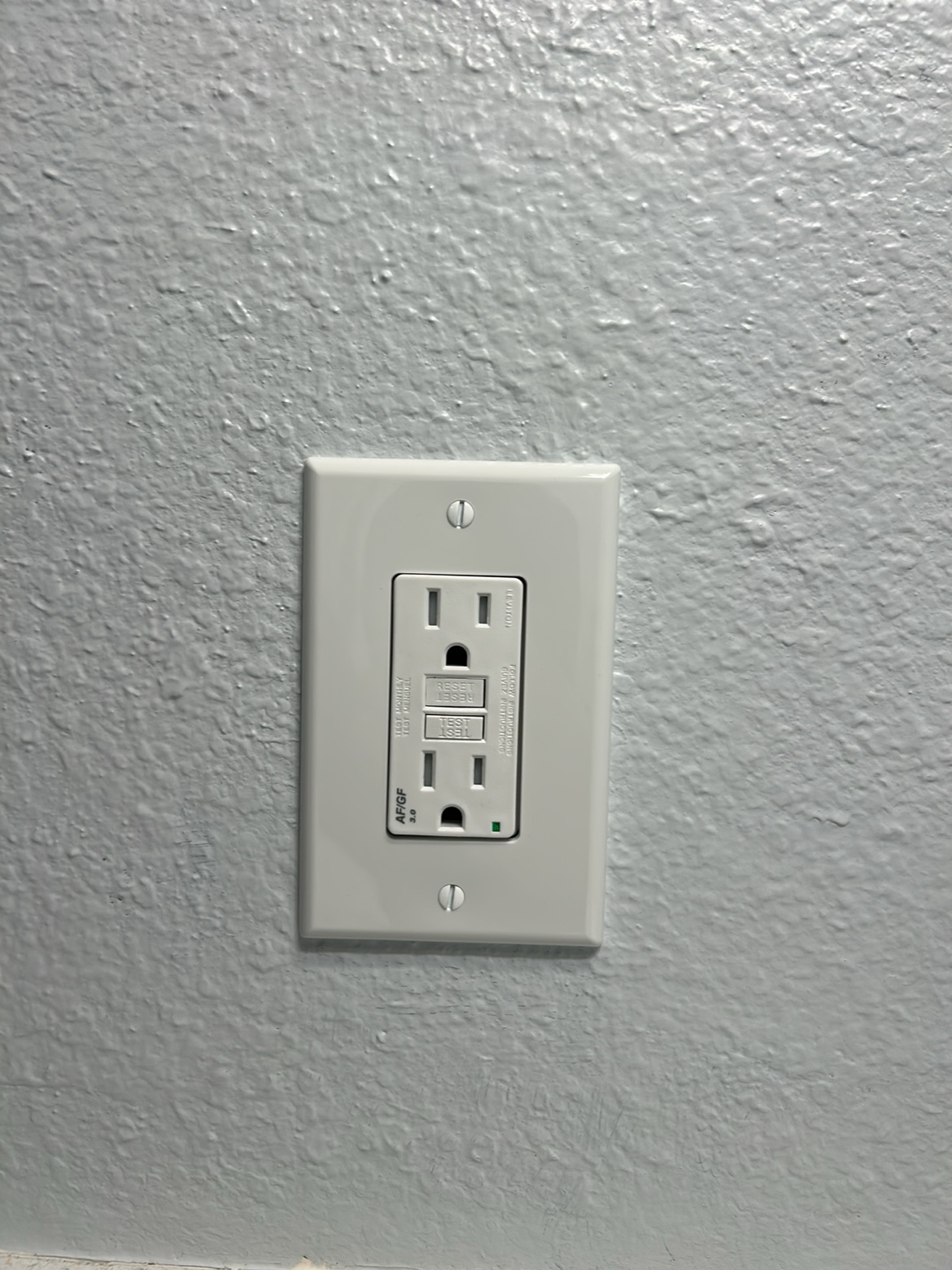 Finished GFCI/AFCI outlet on a wall installed by Washington Electrical