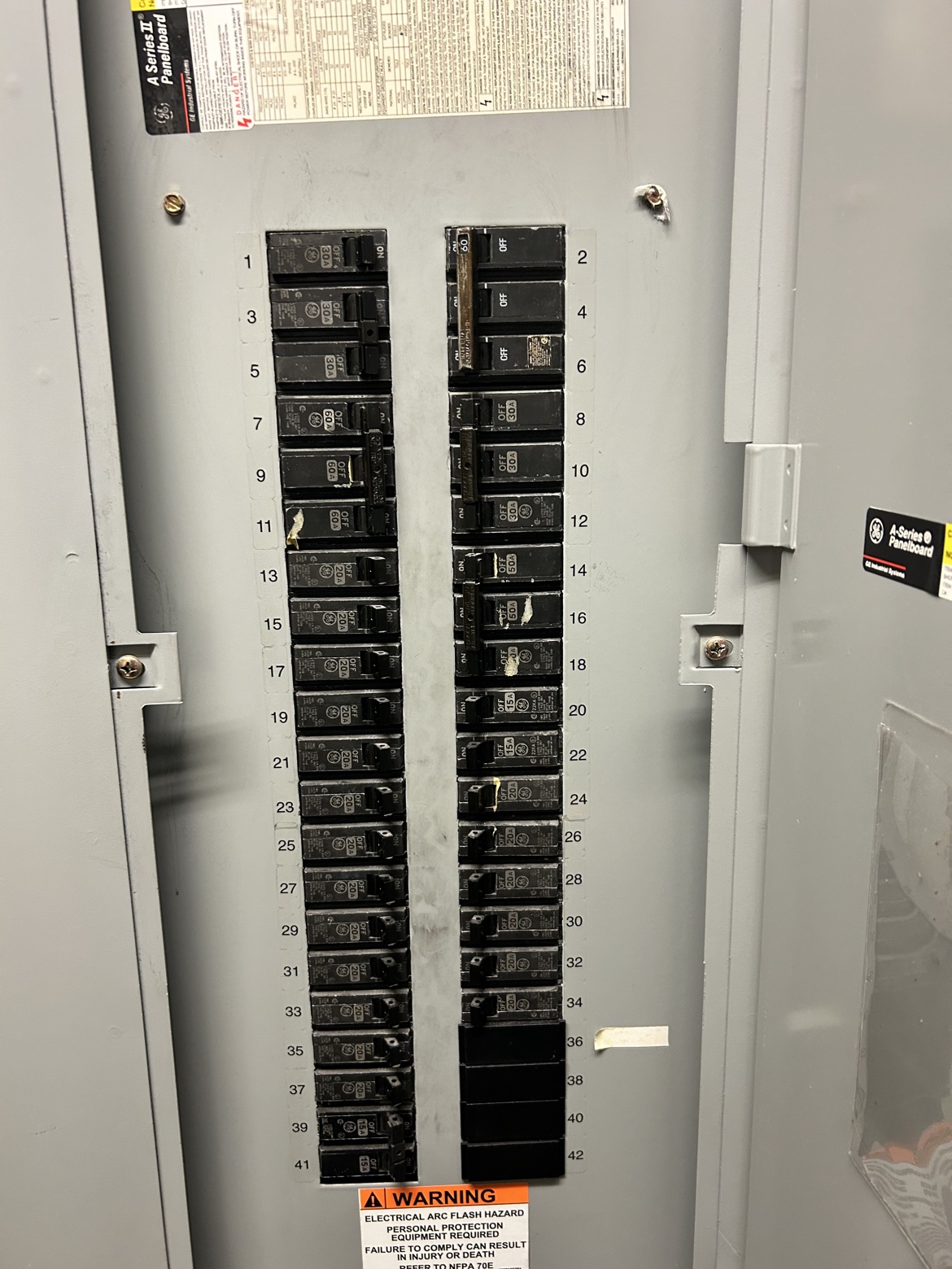 Electrical panel interior with numbered circuit breakers, Washington Electrical