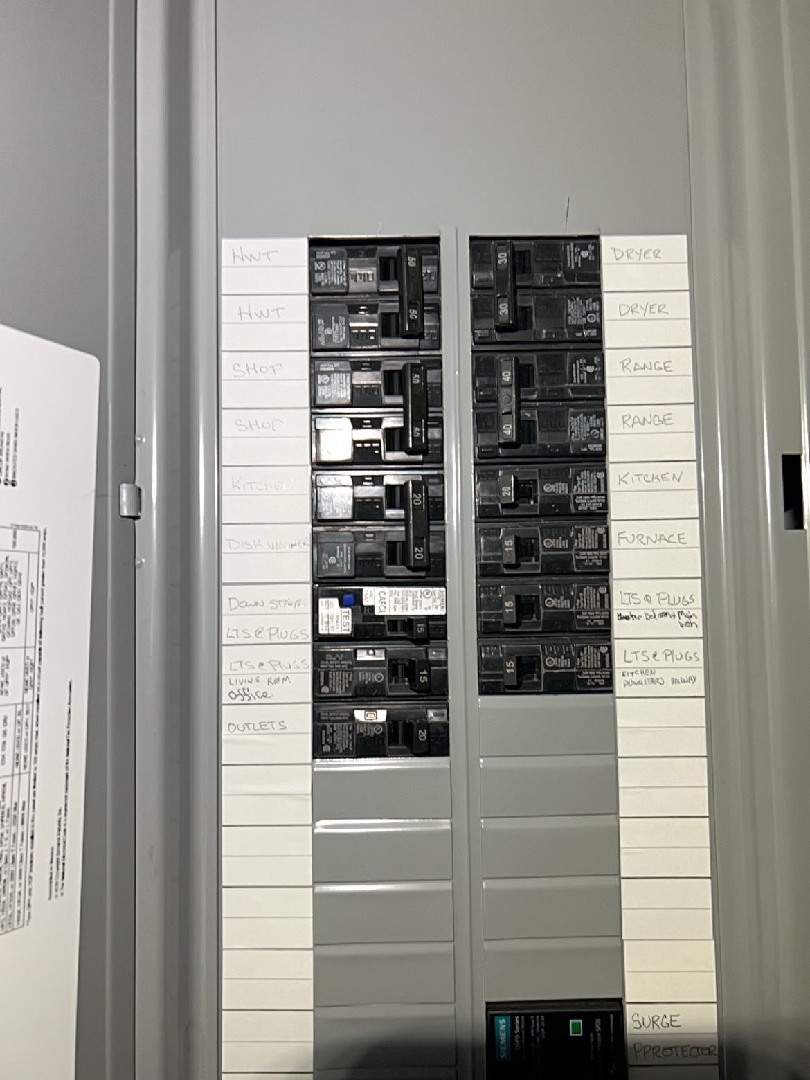 Labeled electrical panel with handwritten directory and surge protection, Washington Electrical
