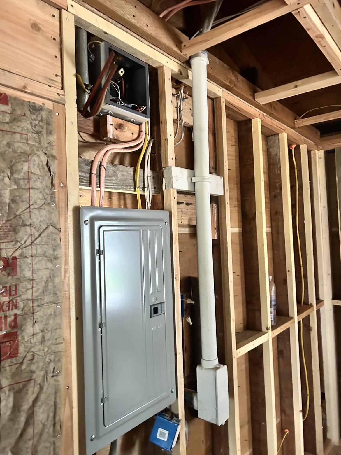 Electrical panel in open framing with rough-in wiring, Washington Electrical