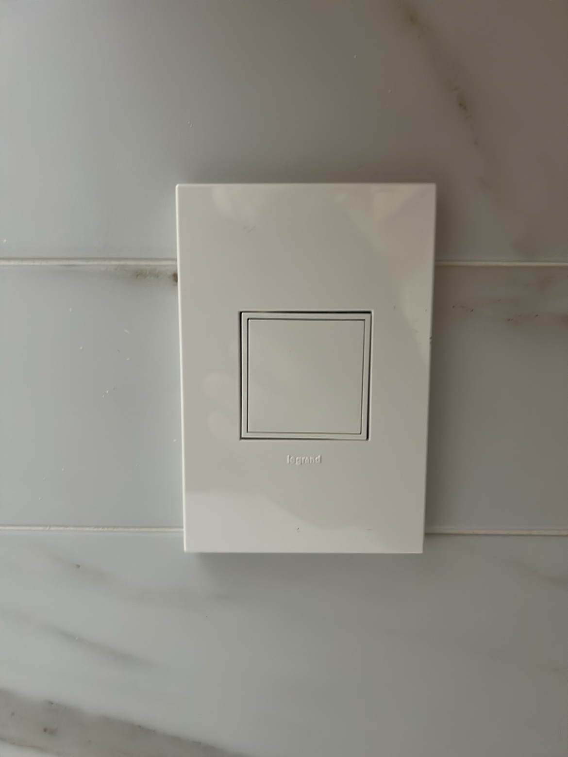 Legrand light switch close-up on tile, Washington Electrical