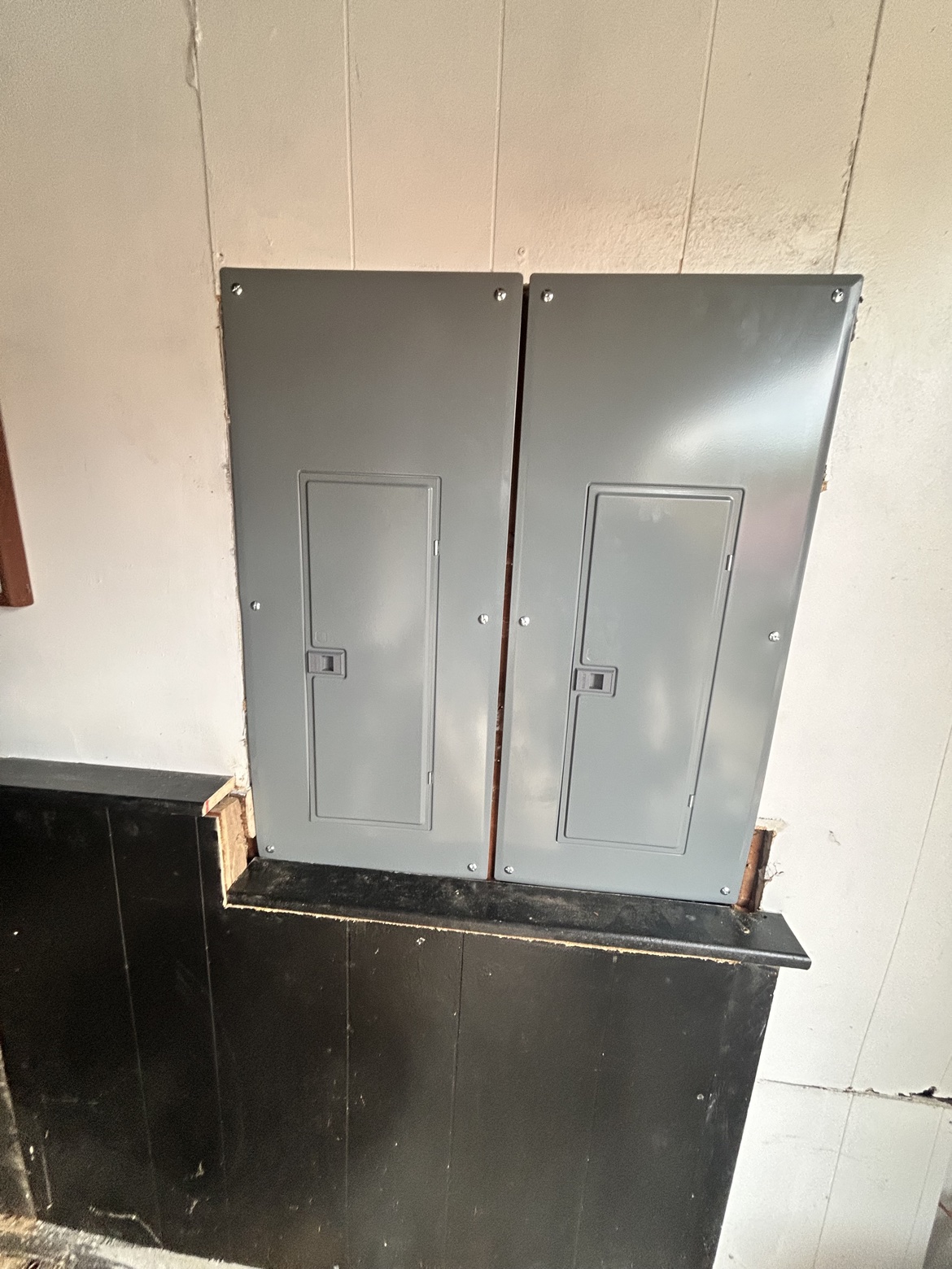 Two new electrical panel covers side by side, finished install by Washington Electrical