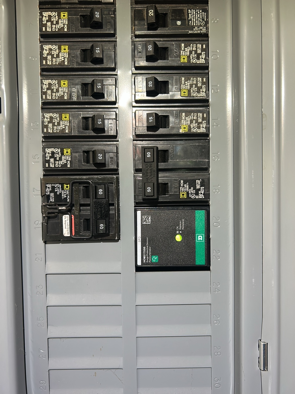 Electrical panel interior with Square D breakers and a surge protection device installed by Washington Electrical