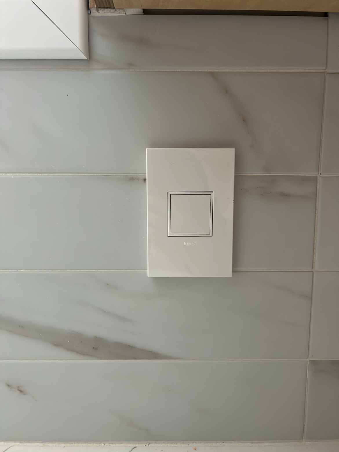 Legrand light switch on tile wall, Washington Electrical